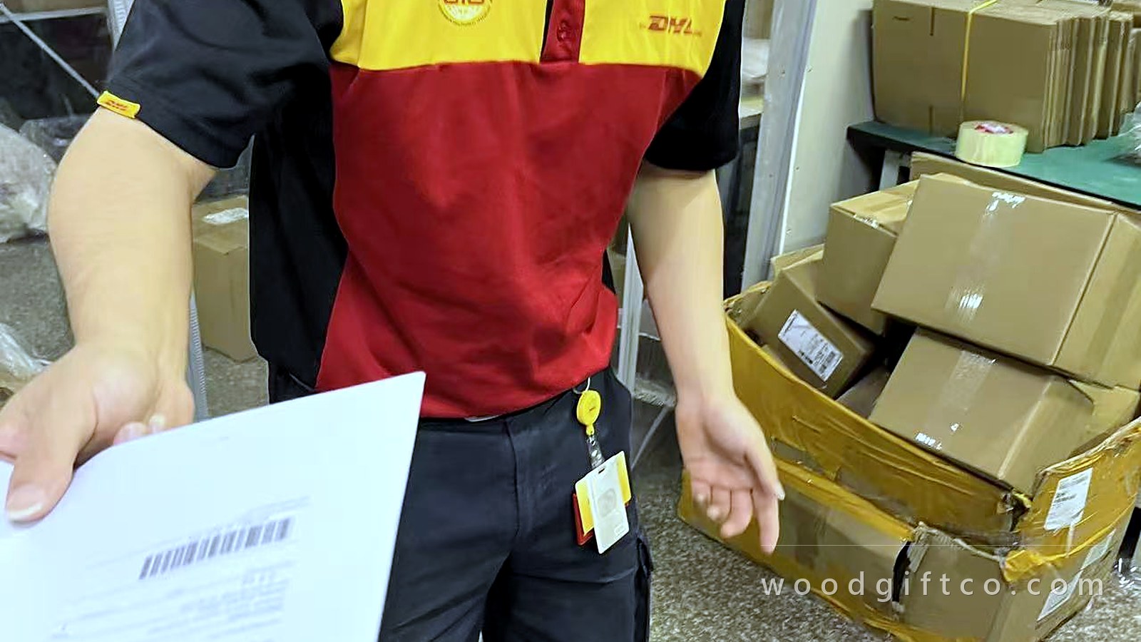 A DHL courier collecting cartons from the workshop